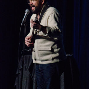 Horatio Sanz playing guitar on stage