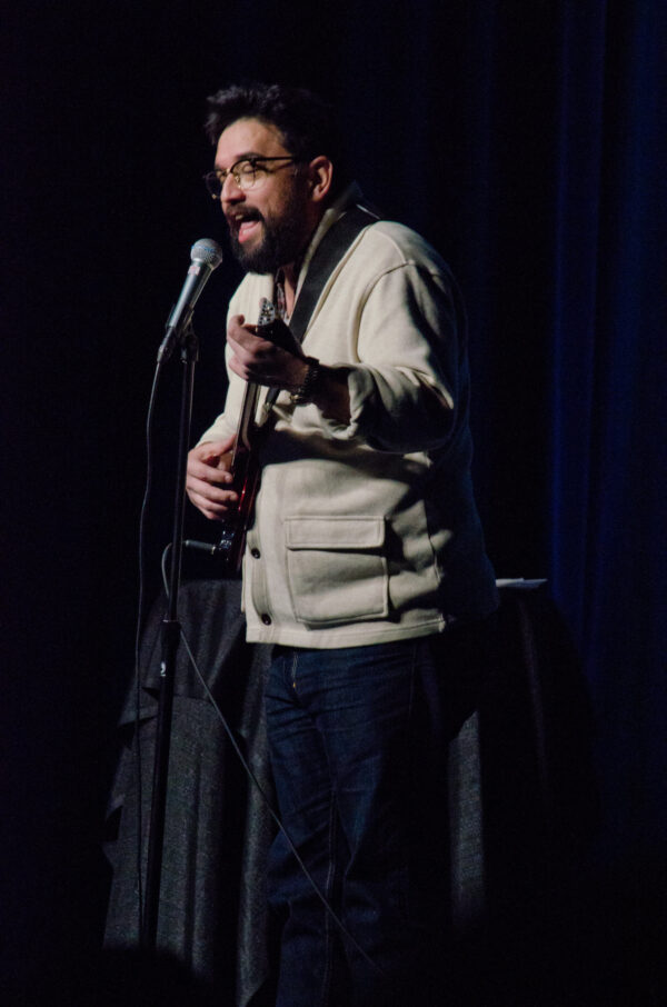 Horatio Sanz playing guitar on stage